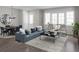 Bright living room with contemporary furnishings, including a blue sofa, chairs, and a coffee table at 947 Willingham Dr # 2, Hapeville, GA 30354