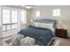 Serene main bedroom featuring a cozy bed, soft lighting, and access to a balcony through french doors at 947 Willingham Dr # 2, Hapeville, GA 30354