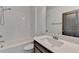 Bright bathroom featuring a tub and shower combination with a modern single sink vanity at 1273 Harvest Park Ln, Suwanee, GA 30024