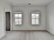 Bedroom features two windows with blinds, neutral carpeting and white walls at 1273 Harvest Park Ln, Suwanee, GA 30024