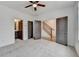 Bedroom with open doors showing access to bathroom and hallway with staircase; neutral carpet at 1273 Harvest Park Ln, Suwanee, GA 30024