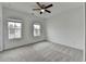 Bedroom features two windows, a ceiling fan, neutral carpeting, and white trim at 1273 Harvest Park Ln, Suwanee, GA 30024