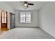 Spacious bedroom with carpet flooring, a ceiling fan, and ample natural light at 1273 Harvest Park Ln, Suwanee, GA 30024