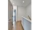 Upstairs hallway features a wood floor and view into a bedroom at 1273 Harvest Park Ln, Suwanee, GA 30024