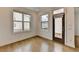 Bright room features hardwood floors, two windows, and a sliding door to a small deck at 1273 Harvest Park Ln, Suwanee, GA 30024