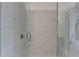 Modern shower with marble-style tiling, glass enclosure, and convenient built-in seat at 1273 Harvest Park Ln, Suwanee, GA 30024