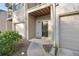 Townhome entrance with a brick facade, covered entry, and single car garage at 1843 Broad River Rd, Atlanta, GA 30349