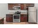 Well-equipped kitchen featuring stainless steel appliances and rich wood cabinetry, perfect for culinary enthusiasts at 1843 Broad River Rd, Atlanta, GA 30349