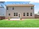 A spacious backyard with a patio and a well-maintained lawn and neutral siding at 405 Blue Sky Circle Cir, Acworth, GA 30102