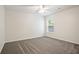 Spacious bedroom featuring plush carpeting, a ceiling fan, and a view from the window at 405 Blue Sky Circle Cir, Acworth, GA 30102