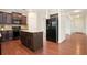 Well-equipped kitchen featuring dark cabinets, a center island, and stainless steel appliances at 405 Blue Sky Circle Cir, Acworth, GA 30102