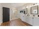Modern bathroom features double vanity, frameless glass shower, and elegant fixtures at 945 Willingham Dr # 3, Hapeville, GA 30354