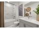 Modern bathroom featuring marble tiling, a soaking tub, and sleek fixtures at 98 Keown Loop, Sharpsburg, GA 30277