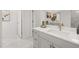Modern bathroom featuring marble floors, gray vanity with white countertops, and decorative gold fixtures at 98 Keown Loop, Sharpsburg, GA 30277