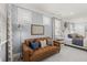 Open bedroom layout with sofa, natural light from multiple windows, and neutral tones for a modern look at 98 Keown Loop, Sharpsburg, GA 30277
