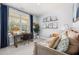 Bright bedroom featuring a large window, desk, and neutral tones, perfect for study and relaxation at 98 Keown Loop, Sharpsburg, GA 30277