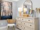 Bedroom decor featuring a wooden dresser with a large mirror and decorative artwork above at 98 Keown Loop, Sharpsburg, GA 30277