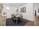 Bright dining room features white wainscoting, modern decor, and seating for four at 98 Keown Loop, Sharpsburg, GA 30277