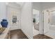 Inviting entryway featuring hardwood floors, bright natural light, and modern decor with convenient access to the bathroom and living spaces at 98 Keown Loop, Sharpsburg, GA 30277