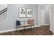 Inviting entryway bench with pillows sits near artwork and hardwood stairs at 98 Keown Loop, Sharpsburg, GA 30277