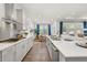 Open-concept kitchen with sleek countertops, modern appliances, and a connected dining area at 98 Keown Loop, Sharpsburg, GA 30277