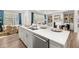 Open-concept kitchen features a large island, stainless steel appliances, and ample counter space at 98 Keown Loop, Sharpsburg, GA 30277