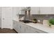 Modern kitchen features stainless steel appliances, gray backsplash and grey cabinetry at 98 Keown Loop, Sharpsburg, GA 30277