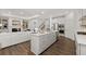Open-concept kitchen features stainless appliances, an island and lots of natural light at 98 Keown Loop, Sharpsburg, GA 30277