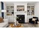 Living room with fireplace, built-in bookshelves, and comfortable seating at 98 Keown Loop, Sharpsburg, GA 30277