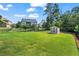 Spacious backyard with well-maintained lawn, storage shed, and secure black metal fencing at 105 Laurel Canyon Trl, Canton, GA 30114