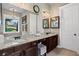 Bathroom with granite countertops, undermount sinks, framed mirrors, and chandelier lighting at 105 Laurel Canyon Trl, Canton, GA 30114