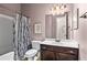 Well-lit bathroom features a bathtub with shower, vanity with sink, and a mirror at 105 Laurel Canyon Trl, Canton, GA 30114
