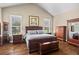 Spacious bedroom features wood floors, tray ceilings, and an abundance of natural light from the windows at 105 Laurel Canyon Trl, Canton, GA 30114