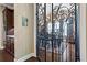 Dining room view through decorative iron gate with chandelier and hardwood floors at 105 Laurel Canyon Trl, Canton, GA 30114