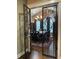 View of the dining room through decorative iron doors, showcasing chandelier and hardwood floors at 105 Laurel Canyon Trl, Canton, GA 30114