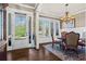 Elegant dining area featuring a chandelier, rich hardwood floors, and bright natural lighting at 105 Laurel Canyon Trl, Canton, GA 30114