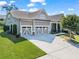 Home exterior featuring a three-car garage, well-kept lawn and attractive landscaping at 105 Laurel Canyon Trl, Canton, GA 30114