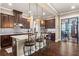 Stylish kitchen with granite island, pendant lighting, dark wood cabinets, and bar stool seating at 105 Laurel Canyon Trl, Canton, GA 30114