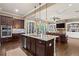Bright kitchen showcasing a granite island, stainless steel appliances, and dark wood cabinetry at 105 Laurel Canyon Trl, Canton, GA 30114