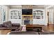 Inviting living room with stone fireplace, custom built-ins, and hardwood floors at 105 Laurel Canyon Trl, Canton, GA 30114