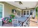Covered patio featuring dining and seating areas, ceiling fans, and a view of the fenced backyard at 105 Laurel Canyon Trl, Canton, GA 30114