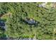 An aerial shot reveals a cozy home embraced by dense, mature trees, creating a private retreat at 1252 Grist Mill Dr, Acworth, GA 30101