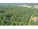 An aerial view featuring a community surrounded by forest, illustrating the neighborhood layout and serene setting at 1252 Grist Mill Dr, Acworth, GA 30101