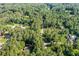 An aerial view of a beautiful home surrounded by lush green trees in a serene neighborhood at 1252 Grist Mill Dr, Acworth, GA 30101
