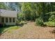 A view of the tranquil backyard bordered by trees with sunlight streaming through at 1252 Grist Mill Dr, Acworth, GA 30101