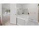 Luxurious bathroom featuring a large soaking tub, a tiled floor, and an oversized mirror at 1252 Grist Mill Dr, Acworth, GA 30101