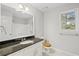 Well-lit bathroom featuring a white vanity with granite countertop, a toilet, and a tub and shower combination at 1252 Grist Mill Dr, Acworth, GA 30101
