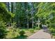 View of long driveway leading to a residence surrounded by mature trees at 1252 Grist Mill Dr, Acworth, GA 30101