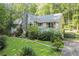 Charming home featuring a stone chimney, red shutters, and mature landscaping at 1252 Grist Mill Dr, Acworth, GA 30101