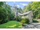 Charming home with stone chimney, surrounded by mature trees and well-maintained lawn at 1252 Grist Mill Dr, Acworth, GA 30101